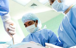 group of doctors prepping for back surgery