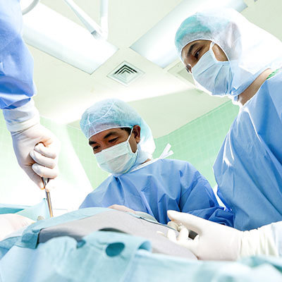 group of doctors prepping for back surgery