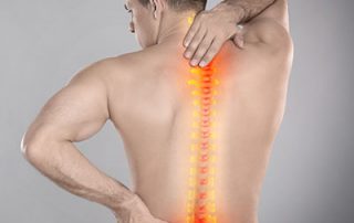 man holding back in pain