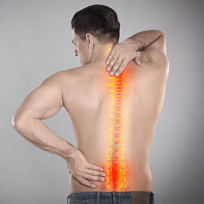 man holding back in pain