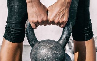 Woman holding kettlebell for strength training